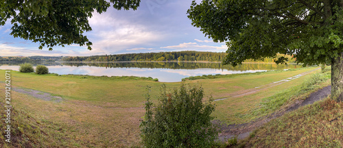 Serene lake view surrounded by lush green forests