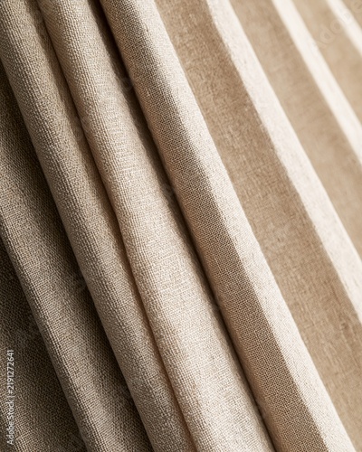 Curtain fabric linen beige stripe texture fold drapery textile close up of neutral woven cloth with soft pleat, vertical pattern, natural fiber, home decor, interior design background