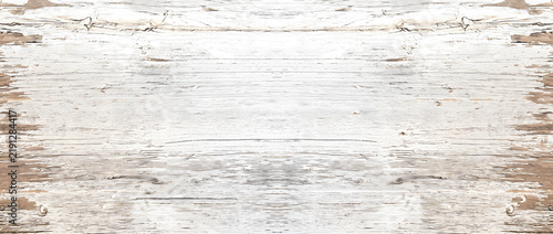 Shabby chic wood texture background showing white peeling paint on rustic timber boards with exposed brown edges for vintage design