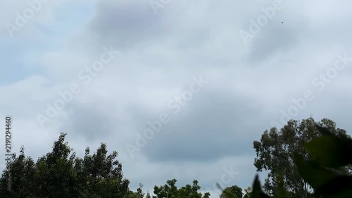 fluffy clouds drifting across a dark blue sky, timelapse clouds on a rainy day, moving clouds