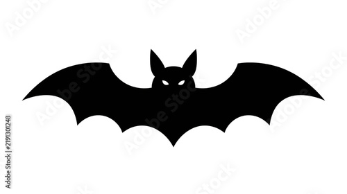 Black silhouette of a flying bat with pointed ears and glowing eyes