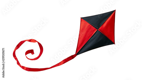 Foto Red and black diamond shaped kite with a long flowing tail