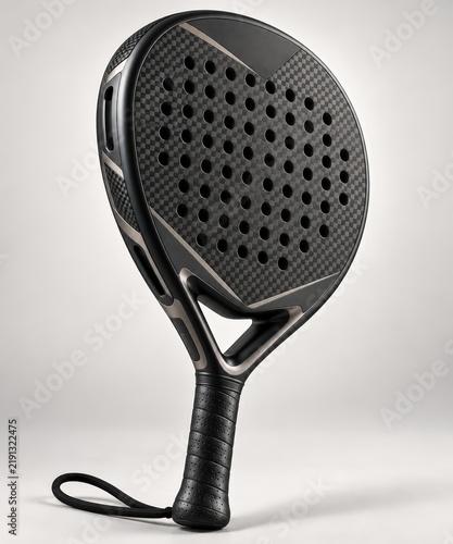 Stylish black padel racket featuring a robust carbon fiber pattern and numerous perforations, captured at an appealing angle against a soft gray studio backdrop.