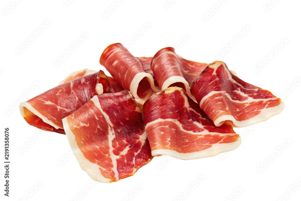 Fototapeta premium Thinly sliced cured jamon iberico ham rolled into small bundles isolated on a transparent background