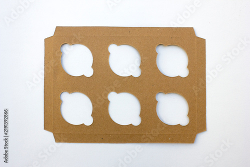 Brown cardboard insert tray with six round holes for product packaging