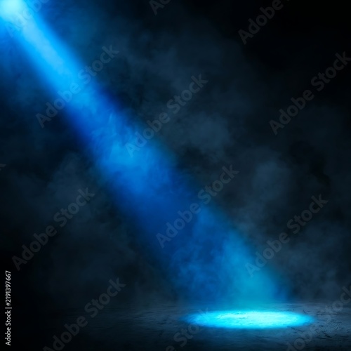 Blue spotlight beam in dark smoky room, dramatic stage lighting with fog, cinematic theater light effect on floor