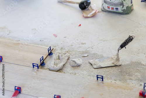 Картината върху платно Laying new wood effect ceramic floor tiles with leveling system