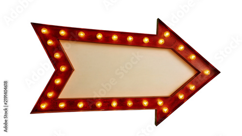Red arrow shaped marquee sign with glowing warm light bulbs