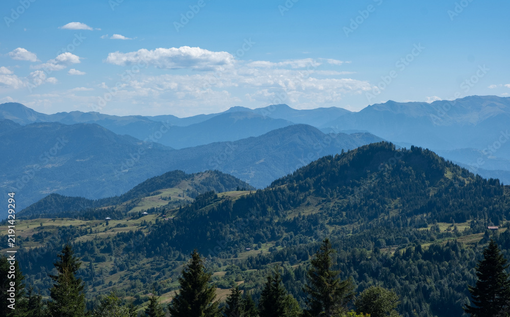 Obraz premium Scenic View of Layered Mountain Ridges Under Clear Sky