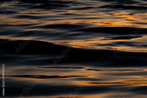 Telephoto Lens Photo of Sunrays Glinting on Ocean Waves at Sunset