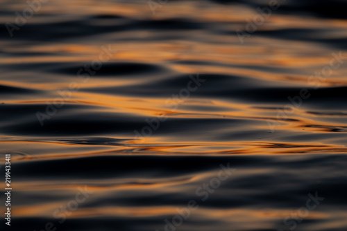 Telephoto Lens Photo of Sunrays Glinting on Ocean Waves at Sunset