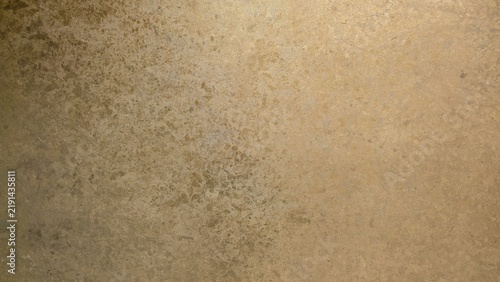 Metallic gold grunge background with textured brush strokes. Abstract gold paint pattern on distressed wall texture. Artistic gold paint finish with rustic overlay, perfect for a luxury backdrop.