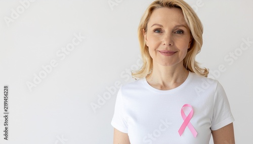 Mature Woman Wearing Pink Ribbon for Breast Cancer Awareness Campaign