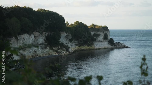 Peaceful Coastal Landscape With Greenery. Quiet Bay Edged With Chalk Cliffs And Lush Trees