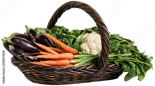 Woven wicker basket filled with fresh raw vegetables including carrots and eggplant