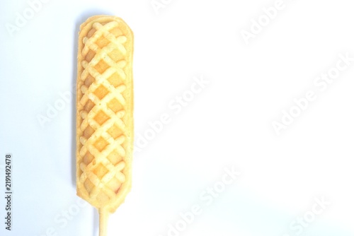 baked butter waffle corn dog stuffed pork sausage stabbing wooden stick isolated on white background