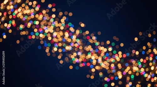 Colorful festive bokeh lights forming a glowing wave on a dark blue background