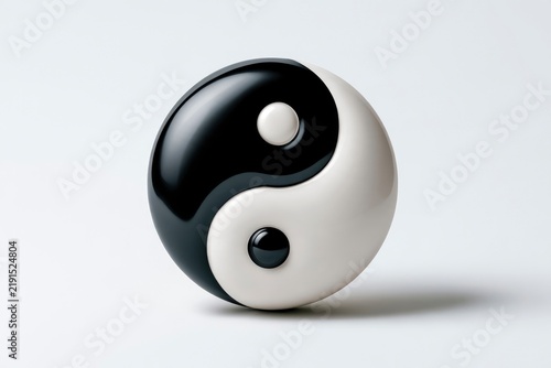 Yin yang sphere resting on white minimalist surface with soft studio lighting and sharp focus for spiritual wellness marketing