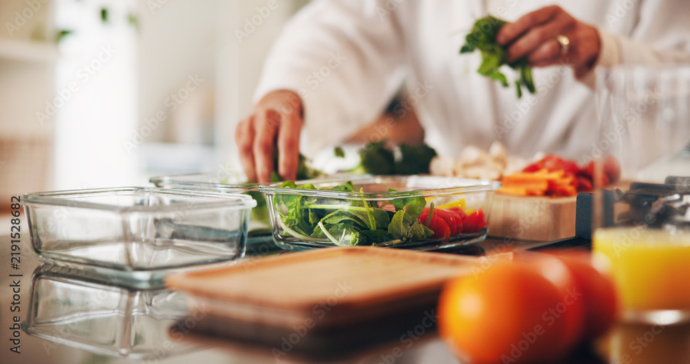 Obraz premium Person, hands and meal prep with food container in kitchen for healthy detox or ready made snack. Culinary artist, chef or vegetables with ingredients for diet, wellness or eating plan in home