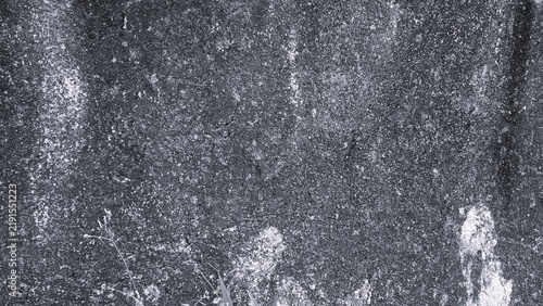 Dark monochrome concrete texture with fine grain, weathered surface, subtle cracks and uneven patterns, creating a raw industrial background for design projects.
