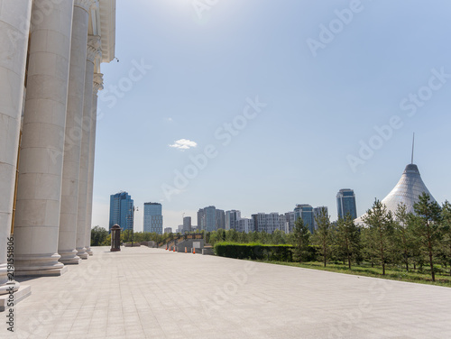 Obraz na plátne Distant view of Khan Shatyr Entertainment Center surrounded by modern high-rise buildings and green trees in Astana, Kazakhstan