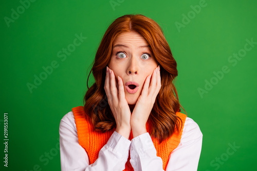 Konstfotografi Surprised redhead woman with hands on cheeks expressing shock and astonishment,