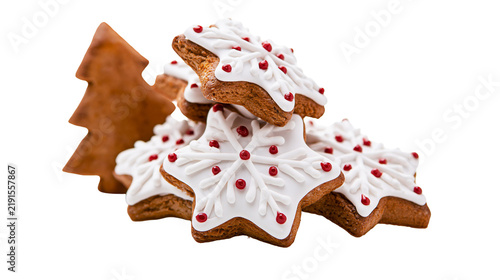 Gingerbread star cookies with white icing and red sugar pearls and tree cookie