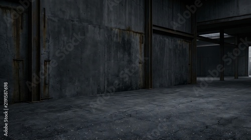 Dark empty industrial warehouse interior with concrete walls and moody shadow lighting