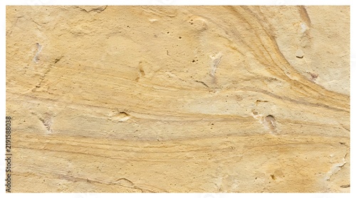 Close up of textured sandstone rock surface with natural patterns and warm earthy tones