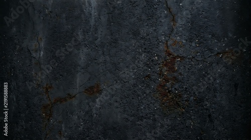 Dark grey concrete wall texture with deep cracks and weathered stone surface details