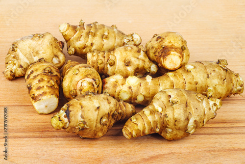 Jerusalem artichoke isolated on wooden background