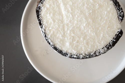 Creamy coconut ice cream served in natural coconut shell closeup