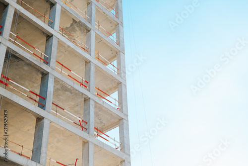 Принти на полотні A construction site features a partially built concrete structure with exposed floors and scaffolding
