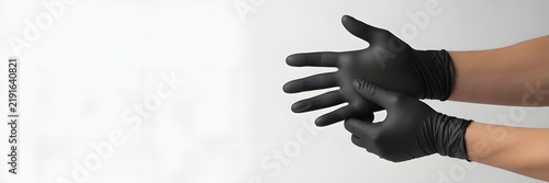 Person with both hands covered in black protective gloves ready for a task