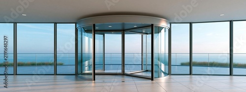 Modern glass revolving door in luxury office lobby with sea view exterior