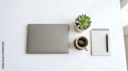 Minimalist Workspace with Laptop Notebook and Coffee on White Desk