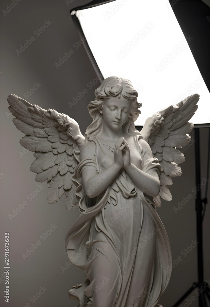 Fototapeta premium Spirituality and faith concept, marble angel statue with praying hands and wings in a studio lighting setup for religious and memorial design projects