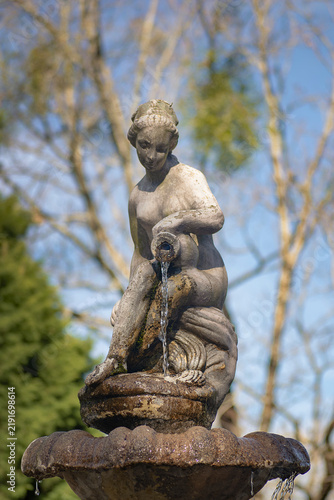 Sculpture with flowing water in an outdoor setting