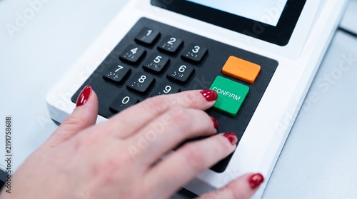 Woman's hand with red nails pressing the confirm button on a voting machine. Brazil's electronic voting machine. Elections in Brazil.