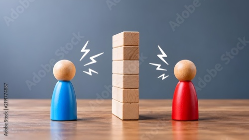 Two wooden figures separated by a block wall with lightning symbols representing workplace conflict and communication barriers
