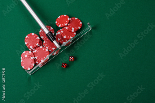 Dice and chips on a green felt gaming table, a poker game in a casino. Casino dice