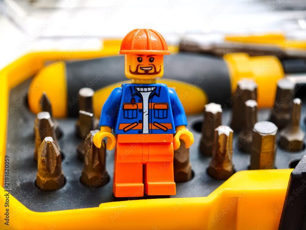 Fototapeta premium Russia, St. Petersburg, August 8, 2020 A lego man standing in front of a bunch of screws, great for DIY or construction theme