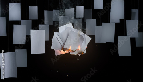 Foto Burning Suspended Papers in Dark Empty Room Concept