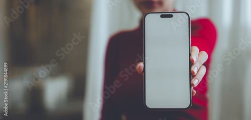 Принти на полотні A person holding a blank smartphone and takeaway coffee, representing mobile communication, modern lifestyle, digital technology, and everyday convenience