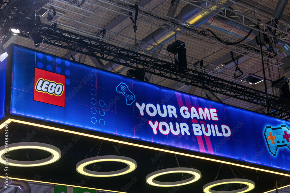 Obraz premium Cologne, Germany - August 26, 2026: LEGO booth display at gamescom featuring vibrant graphics and the slogan 