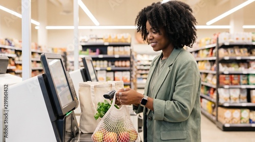 Woman scanning fresh produce at self checkout kiosk