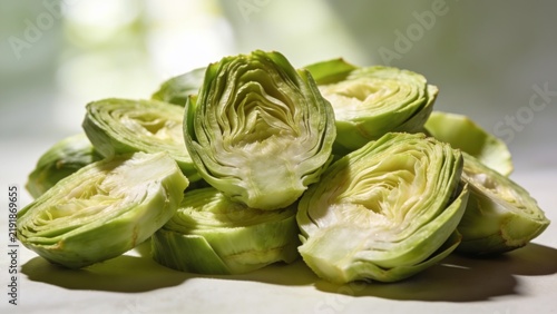 Fresh green artichoke hearts cut for cooking