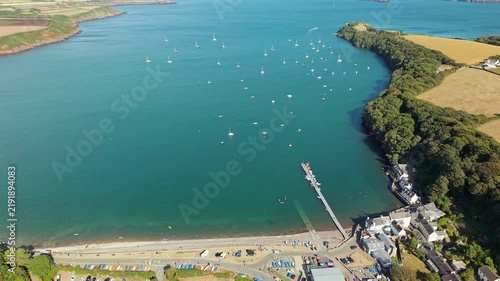 Aerial view of Dale Bay in Pembrokeshire, Wales, showing boats moored on calm blue water with green fields and coastline stretching into the distance
