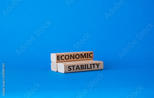 Economic stability symbol. Concept word Economic stability on wooden blocks. Beautiful blue background. Business and Economic stability concept. Copy space