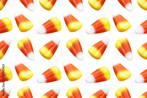 Repeating seamless pattern of candy corn pieces on transparent background	